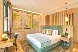 a bedroom with a bed and a table and a desk at The Wings Hotels Pera in Istanbul +130 photos
