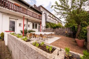 a patio with a table and chairs in front of a building at Hotel Schwan in Eschweiler