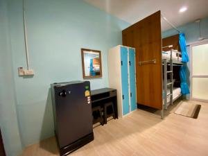 a room with a refrigerator and a bunk bed at Riverside Pak Nakon Restaurant & hostel in Ban Ko Mai Phai +10 photos