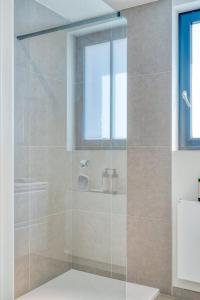 a shower with a glass door in a bathroom at Beautiful 3-Bedroom Home with Garden & Parking in Deinze +22 photos