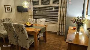 a dining room with a table and chairs and a dining room at Westend House in Goring by Sea