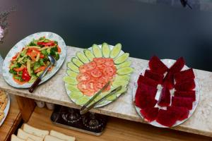 two plates of food on a counter with plates of food at Anh Hotel in Ho Chi Minh City