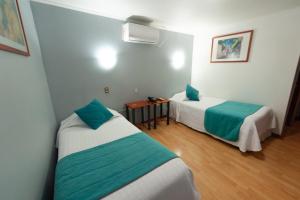 Ένα ή περισσότερα κρεβάτια σε δωμάτιο στο Hotel Real