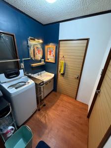 a bathroom with a sink and a door at Hakushu hutte in Hokuto