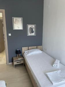 a bedroom with two beds and a table with a mirror at Vesper Rooms in Skala Prinou
