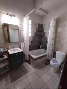 a bathroom with a tub and a toilet and a sink at Kavala Summer in Kavála +6 photos