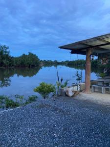 a view of a lake with a pavilion at Riverside Pak Nakon Restaurant & hostel in Ban Ko Mai Phai