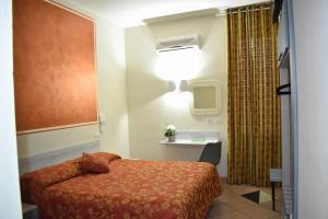 a small room with a bed and a light at HOTEL IL PARCO - Free Parking & On-Site Dining -3- STAR SUPERIOR COMFORT in Grosseto