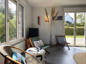 a living room with two chairs and a table at Grande maison au centre de Perros-Guirec avec jardin, terrasse et WIFI - FR-1-368-460 in Perros-Guirec