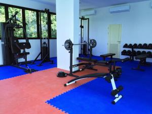 a gym with several treadmills and exercise machines at Happy Place Official in Nai Yang Beach