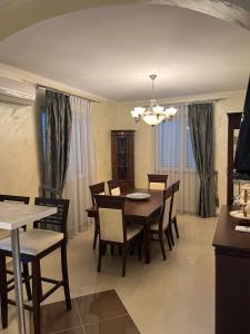 a dining room with a table and chairs at Hara Villa in Bijela