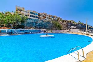 カジャオ・サルバヘにあるOcean Breeze Apartmentsのプールでフリスビーをしている人