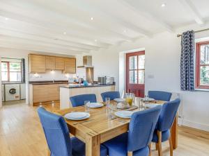 a kitchen and dining room with a wooden table and chairs at 3 Bed in Praa Sands 36258 in Germoe