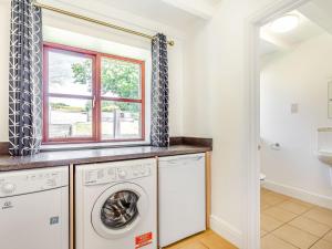 a laundry room with a washer and dryer at 3 Bed in Praa Sands 36258 in Germoe