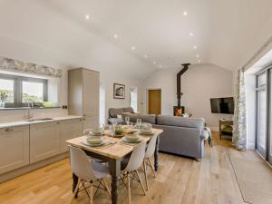 a kitchen and living room with a table and chairs at 3 Bed in Hartland 91183 in Hartland