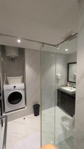a bathroom with a microwave and a sink at Minimalist Designer Style Apartement Branz BSD 1BR in Samporo