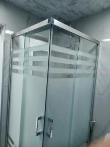 a shower stall with a glass door in a bathroom at The Mountain A-Frame Qusar in Yuxarı Lǝgǝr +7 photos