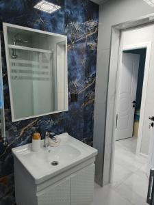 a bathroom with a sink and a mirror at The Mountain A-Frame Qusar in Yuxarı Lǝgǝr