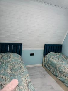 Ένα ή περισσότερα κρεβάτια σε δωμάτιο στο A-Frame A-Frame Chalet -Shahdag & Qusar