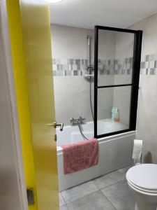 a bathroom with a shower and a tub and a toilet at Studio Confort by Titou - Jumet in Charleroi