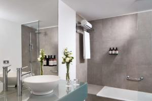 a bathroom with a white sink and a shower at NH Sintra Centro in Sintra