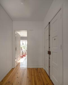an empty hallway with white walls and wooden floors at Flattered to be in Tomar in Tomar
