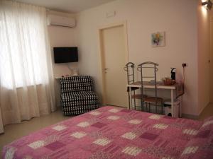 a bedroom with a bed and a table and a window at Sweet Dreams in Pescara