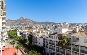 a view of a city with palm trees and buildings at Beautiful Apartment In Benalmadena in Benalmádena
