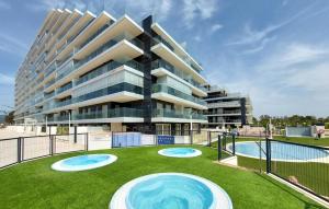 a large apartment building with two frisbees in the grass at Awesome Apartment In Cabanes in Cabanes +14 photos