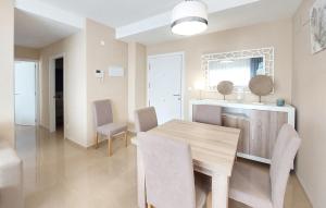 a dining room with a wooden table and chairs at Awesome Apartment In Cabanes in Cabanes