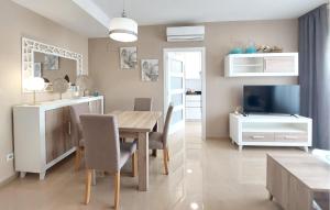 a kitchen and dining room with a table and a television at Awesome Apartment In Cabanes in Cabanes