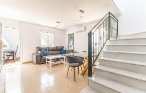 a living room with a staircase and a couch at Awesome Home In Avileses in Avileses