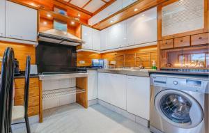 a kitchen with a washer and a washing machine at Awesome Home In Tossa De Mar With Wifi in Tossa de Mar