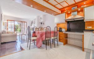 a kitchen and dining room with a table and chairs at Awesome Home In Tossa De Mar With Wifi in Tossa de Mar