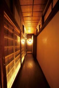 a hallway with a light at the end of a room at Osakaya Hotel & SAUNA in Kaizuka