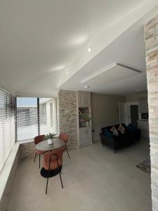 a living room with a table and a couch at Oakdale Lodge in Derrymore Bridge +18 photos