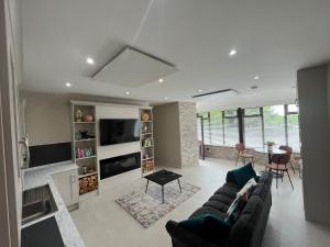 a living room with a couch and a table at Oakdale Lodge in Derrymore Bridge