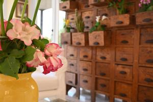 a yellow vase filled with flowers on a table at Hotel B&B Montecarlo in Milano Marittima