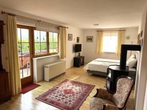 a bedroom with a bed and a chair and a window at Lisa & Gretl's Alpen-Panorama Chalet Saalfelden - 10 Min nach Zell am See in Saalfelden am Steinernen Meer