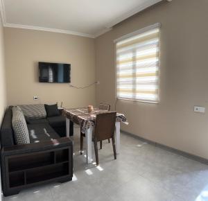 a living room with a table and a couch at LakeSide in Gabala