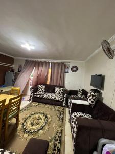 a living room with a couch and a table at 3 Bedroom Chalet at Dimora Village North Coast Egy - الساحل الشمالي - قرية ديمورا - شاليه 3 غرف in Dawwār Muḩammad Abū Shunaynah