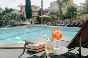 a drink on a table next to a swimming pool at Hesperia Mallorca in Palma de Mallorca