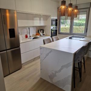 a kitchen with a white counter and a refrigerator at Perbes Dreams in Perbes