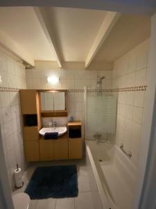 a bathroom with a sink and a bath tub at heerlijk vakantie huis Lovely holiday home in Lanaken