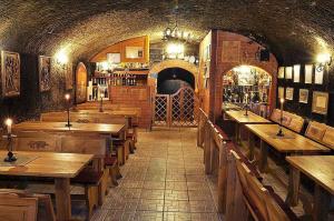 a large room with wooden tables and a bar at Holiday home in Eger - Ostungarn 53339 in Eger +25 photos