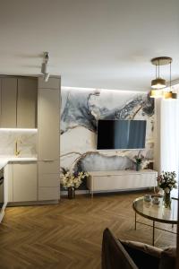 a living room with a tv on a wall at Apartament Valentino Bussines Haven & Family in Kielce