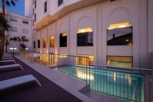a building with a swimming pool next to a building at AP Sines - Costa Alentejana in Sines