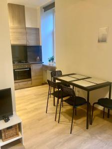 a kitchen and dining room with a table and chairs at Cosy 2-room apartment center Self check-in in Rīga