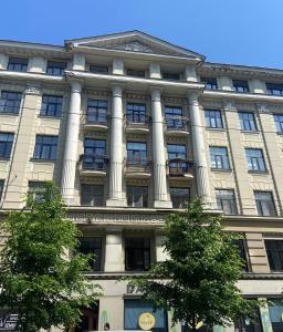 a large building with columns on the side of it at Cosy 2-room apartment center Self check-in in Rīga