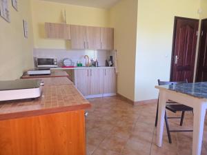a kitchen with wooden cabinets and a counter top at Noce i dnie in Białogóra +18 photos